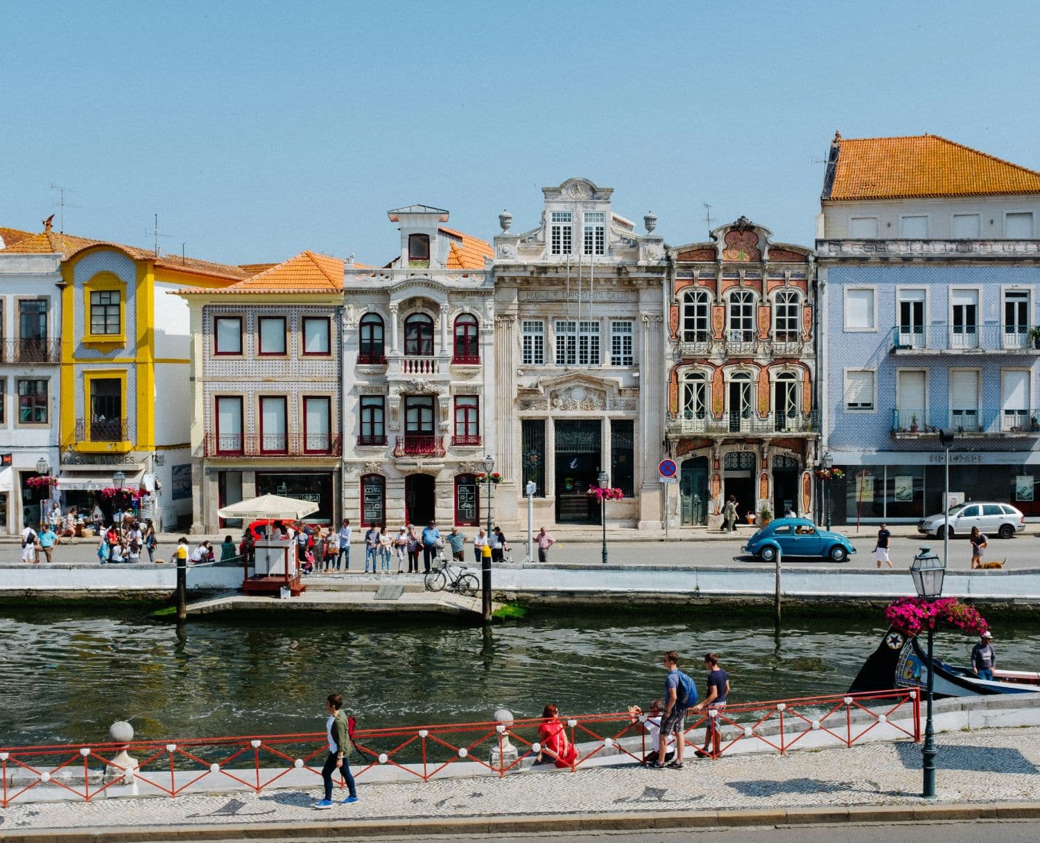 Art Nouveau and tiled façades along the central canal in Aveiro, with a moliceiro boat